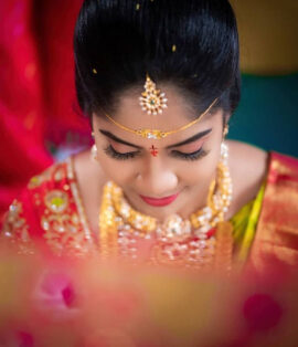 Bride getting ready with wedding makeup artist in Vijayawada