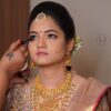 Bride getting HD airbrush makeup by a professional artist at Lush Makeovers Vijayawada