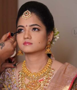 Bride getting HD airbrush makeup by a professional artist at Lush Makeovers Vijayawada