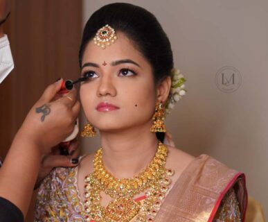 Bride getting HD airbrush makeup by a professional artist at Lush Makeovers Vijayawada