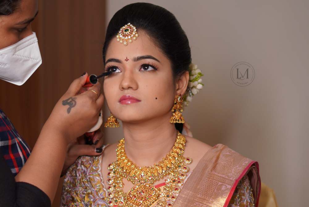 Bride getting HD airbrush makeup by a professional artist at Lush Makeovers Vijayawada