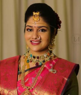 Bride getting makeup done by top makeup artist in Vijayawada at Lush Makeovers studio